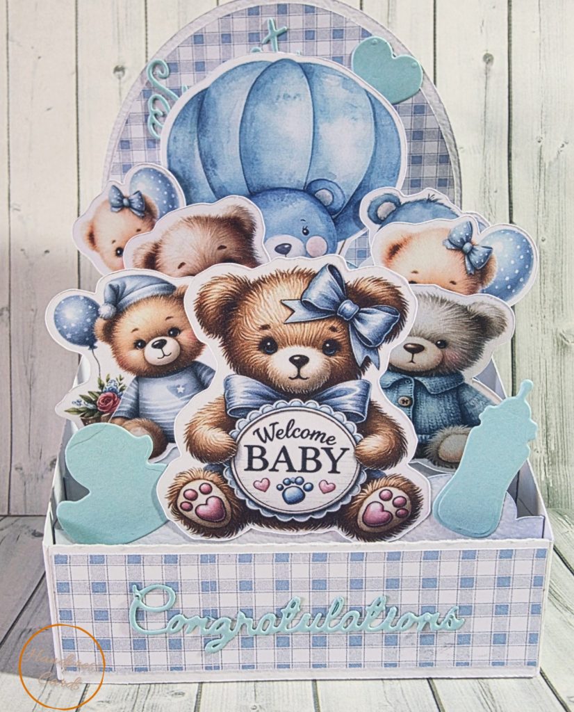 Handmade easel box card with layered die-cut teddy bears and a hot air balloon on a soft blue gingham background with Sweet Baby and Congratulations sentiments in baby blue.