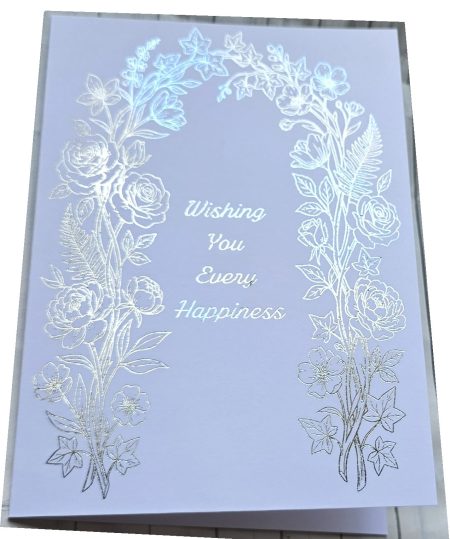 Handmade wedding card featuring a silver foil embossed floral arch with roses peonies and ferns on white card reading Wishing You Every Happiness