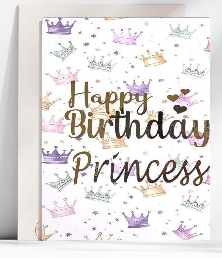 Handmade birthday card featuring a white background scattered with watercolour crowns in pink, purple, mint and gold with Happy Birthday Princess in gold foil calligraphy, with a white envelope behind it.