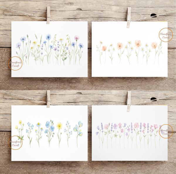 Set of four watercolour wildflower notecards pegged to a rustic wooden backdrop, featuring soft botanical illustrations of meadow flowers including cornflowers, daisies, poppies, lavender and forget-me-nots in pastel watercolour style